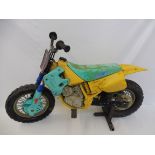 A juvenile motorcycle ride, in the form of a scrambler, with original stand.