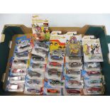 A quantity of carded Hotwheels die-cast cars including The Beatles Yellow Submarine series.