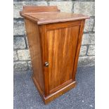 A Victorian mahogany single door bedside cabinet raised upon a plinth base.