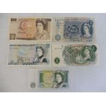 A quantity of bank notes including a £10 note, two £5 notes and two £1 notes.