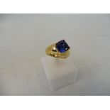 A 9ct gold ring set with a blue stone.