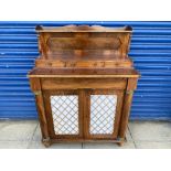 A 19th Century mahogany chiffonier with two brass grille fronted doors flanked by half columns,