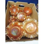 A large quantity of orange coloured carnival glass.