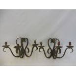 A pair of three branch wrought iron wall lights.