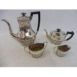 A silver half fluted three piece tea service, Birmingham 1890 and a large silver plated coffee pot.