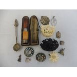 A silver mounted cheroot holder, two micro-mosaic brooches, various other brooches, charms etc.