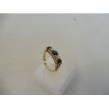 A cased Edwardian diamond and sapphire ring set in 18ct gold.