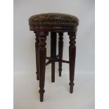 A superb Regency mahogany circular revolving piano stool with patinated green leather (possibly