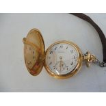 A 14k gold pocket watch.