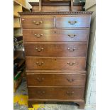 A George III oak chest on chest in two parts, the upper section of two short over three long drawers