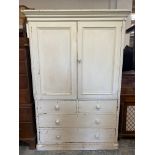 A Victorian painted pine press cupboard in two parts, the upper section enclosing three loose