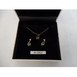 A 9ct gold peridot pendant and earring set.