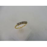 An 18ct gold diamond eternity ring (seven diamonds).