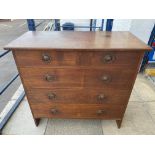 A good quality Arts and Crafts oak chest of two short over three long drawers, with original handles