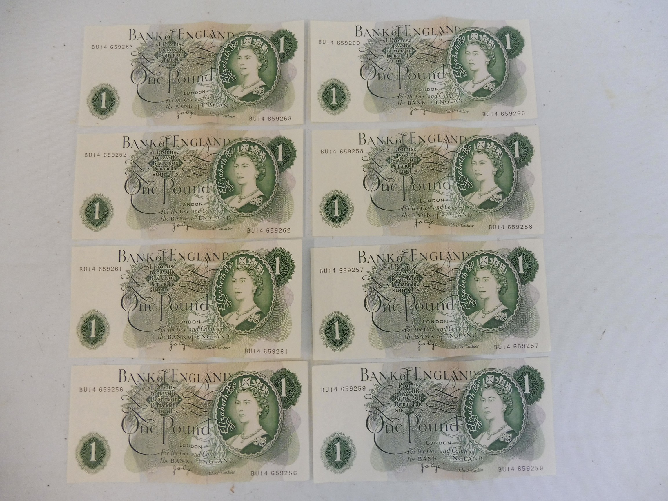 A consecutive run of eight One Pound notes.