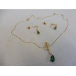 A 14ct gold emerald and diamond pendant and earrings set.