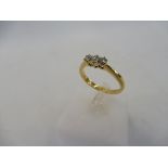 An 18ct gold diamond ring (three diamonds).