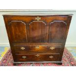 An 18th Century Welsh fruitwood mule chest with three arched panels over two long drawers with brass