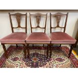 Three Edwardian inlaid rosewood upholstered salon chairs plus an Edwardian open armchair.
