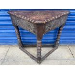 An 18th Century oak credence table with a carved frieze of repeating design above three finely