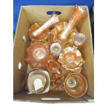 A large quantity of orange coloured carnival glass.