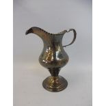 A silver cream jug with armorial, London 1821.