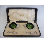 A cased pair of green glass lined silver salts with spoons, London 1916, in original retailer's box,