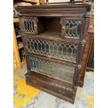 An Edwardian oak globe wernicke style four tier stacking bookcase of three glazed sections abover