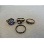 A silver and milifiori glass ring and three further silver rings.
