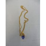 A 9ct gold pendant with blue stone.