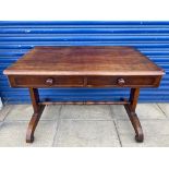 A William IV mahogany two drawer writing table raised upon end supports joined by a stretcher, 40"