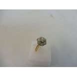 A cased diamond cluster ring.