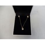 A 9ct gold princess cut diamond set of earrings and pendant.