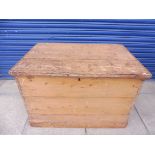 A large 19th Century pine blanket chest with rising lid and two heavy carrying handles, 37 1/2" wide