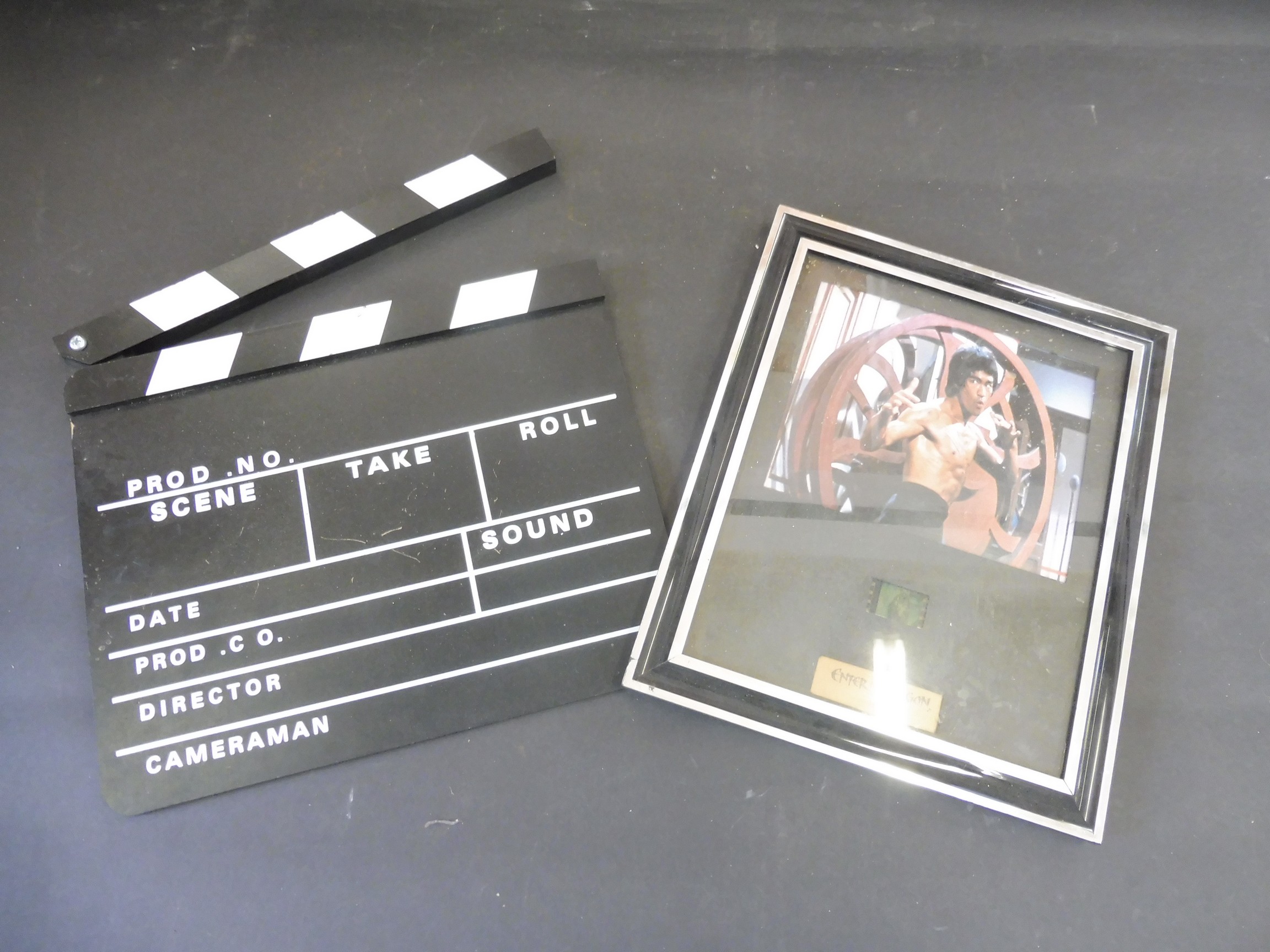 A Jackie Chan 'Enter the Dragon' film cell plus a film making clapper board.