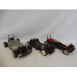Three vintage electric RC chassis', one is Tamiya, one Kyosho and one 4WD shaft.
