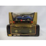 Two 1/18 scale vehicles - a Burago Dodge Viper and a Maisto Jaguar XJ220.