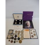 A silver £1 set plus various loose coins.