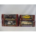 Four 1/18 scale vehicles in boxes - a 1967 VW Beatle, a 1953 Ford F100 truck, a 1958 Cadillac Police