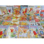 A large selection of Rupert annuals, various eras plus a quantity of Ladybird books and tea cards.