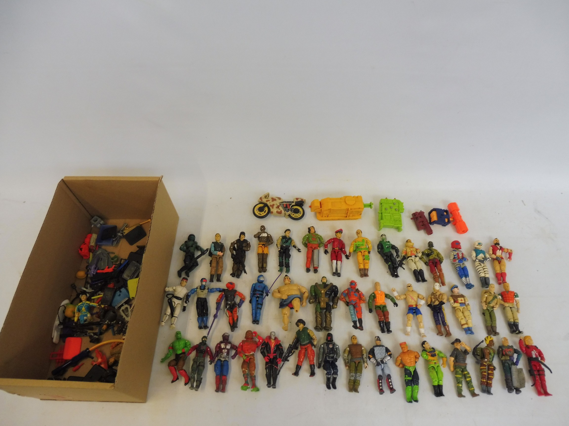 A mixed lot of action figures to include GI Joe and others.