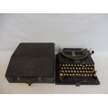 A Remington typewriter in case.