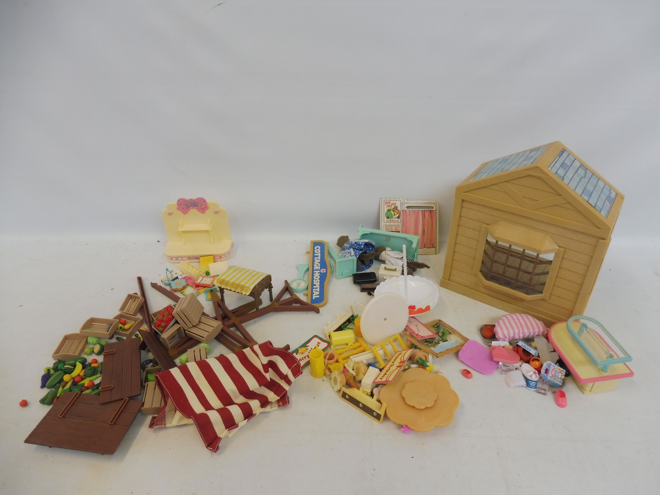 A Sylvanian Family Hosiptal with accessories, a shop shop, gift shop, garden accessories and grocery