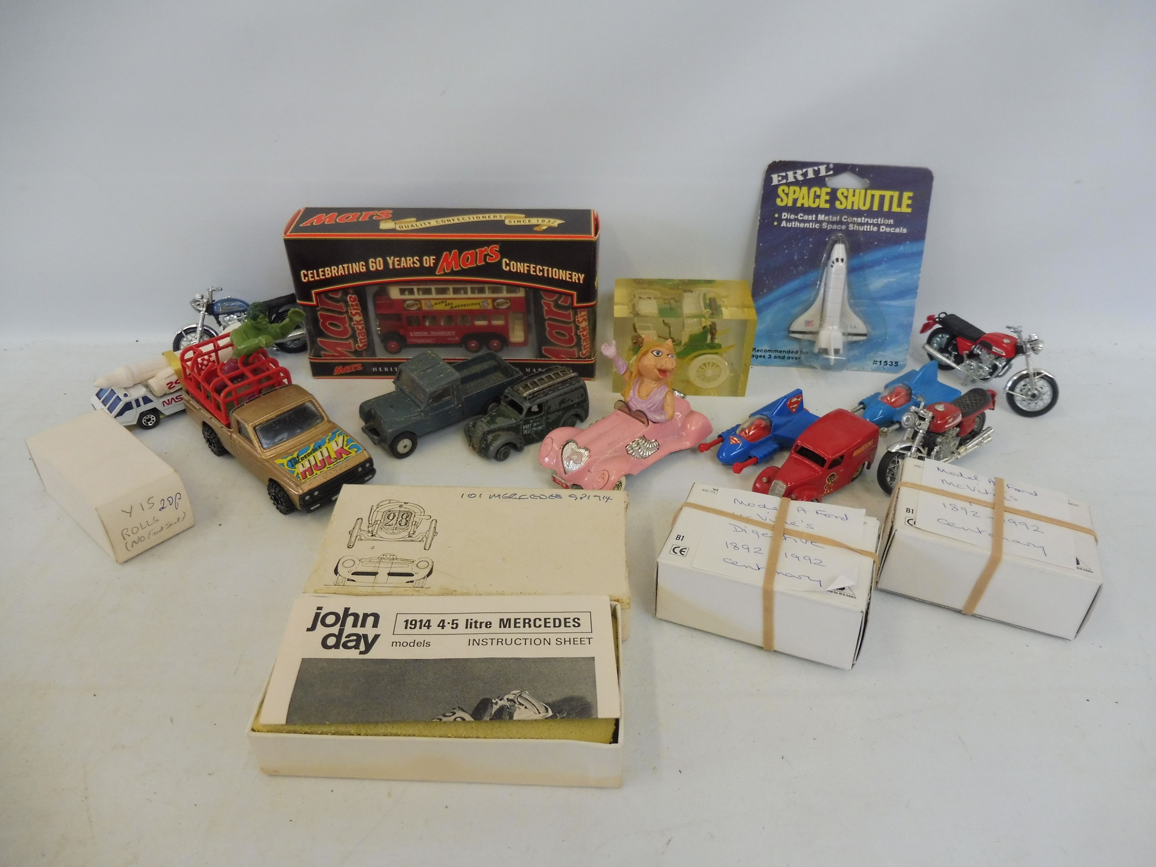 A small box of tv-related die-cast models and others.