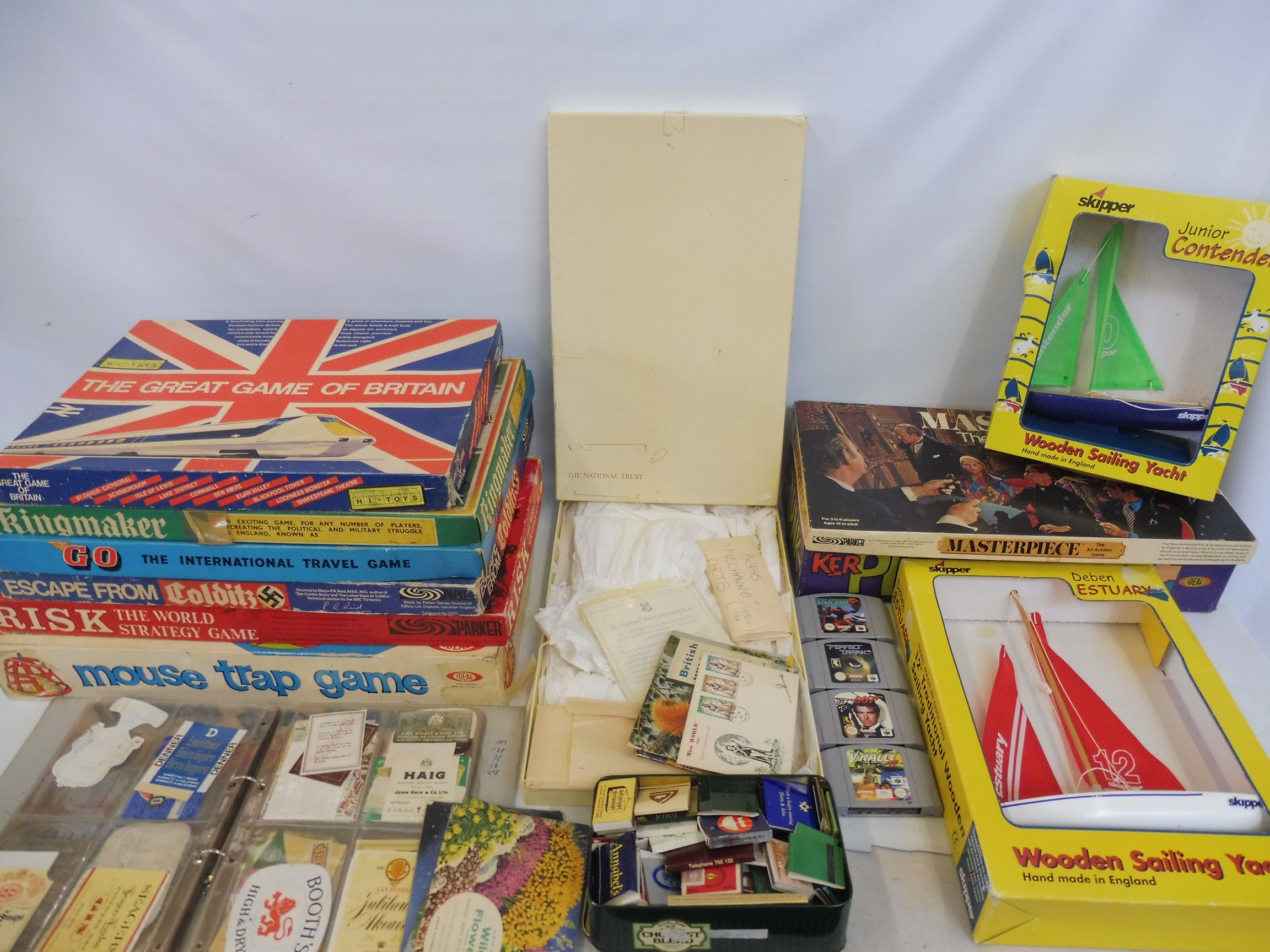 A quantity of board games, tea cards in albums, ephemera, an album of original bottle labels,