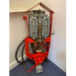 A Watts, Fincham & Co. wall mounted two gallon petrol pump, restored in Shell colours with hose