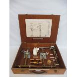 A wooden cased plumbing demonstration set.