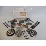 A mixed lot of badges, toy model cars, Shell advertising envelopes etc.