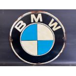 A contemporary circular plastic sign advertising BMW, 31" diameter.