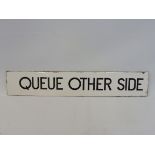 A narrow enamel sign bearing the words 'Queue Other Side', possibly railway or bus related, 15 x 2